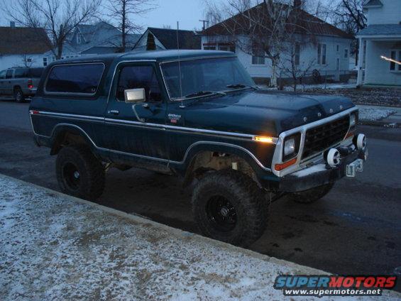 1978 Ford Bronco, dark green, lifted, parked on street