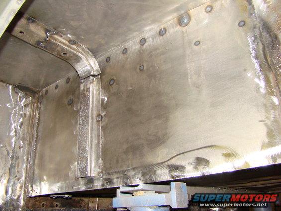 Close-up of a metal interior with many spot welds and some structural bracing