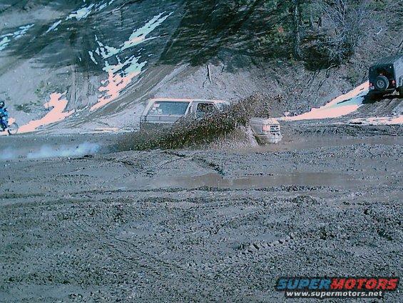 1989 Ford Bronco driving through mud, 3q-front view
