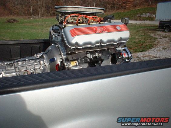 Ford 427 engine and transmission in truck bed. Supermotors.net logo visible