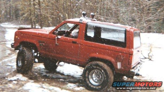 Red 1988 Ford Bronco II off-roading in snow