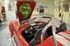 1996 Ford Bronco - Interior view of a red convertible a striking cobra mural painted on the underside of the hood.