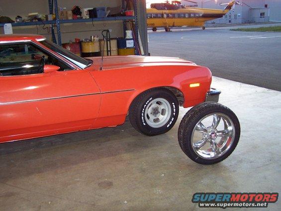 100_1012.jpg these were the aluminum slotted mags that came on the car, and the 18" wheel/tire that I am installing on the front end.