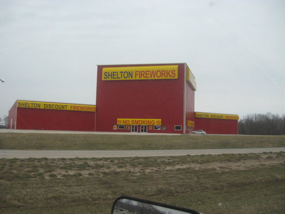 Red building with yellow signs that say Shelton Fireworks and Shelton Discount Fireworks