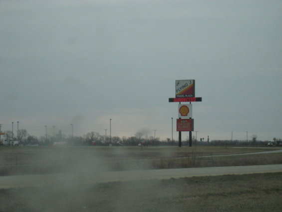 Flying J Travel Plaza sign with Shell logo and 'Guaranteed' text