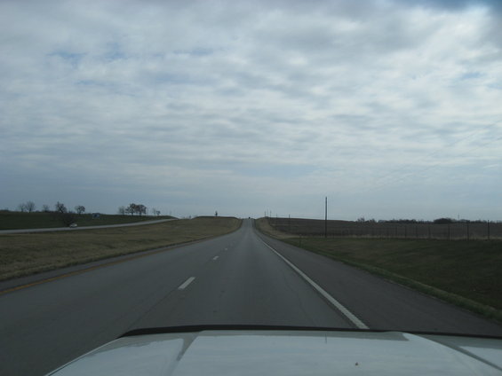 View from car driving on a highway with a cloudy sky