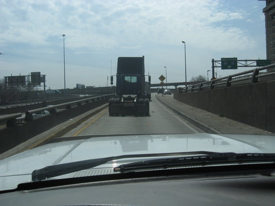 Semi-truck driving on highway, seen from another vehicle's perspective