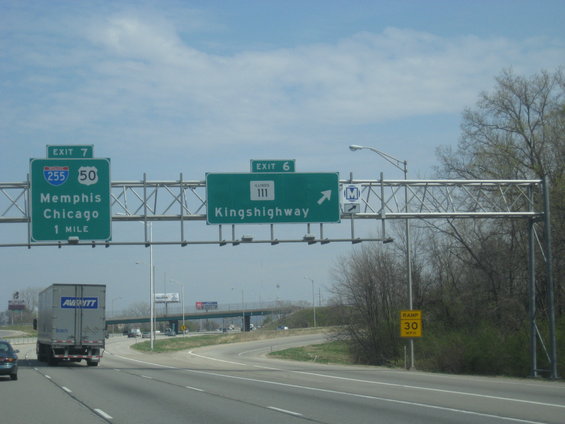 Semi-trailer truck on highway with exit signs for Memphis and Kingshighway