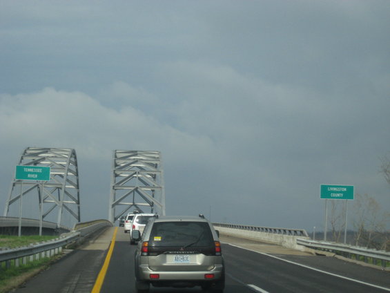 Silver SUV with license plate AB1-83E driving on a bridge over the Tennessee River