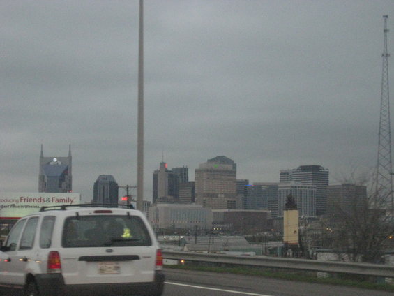 White SUV rear view on highway with Nashville skyline