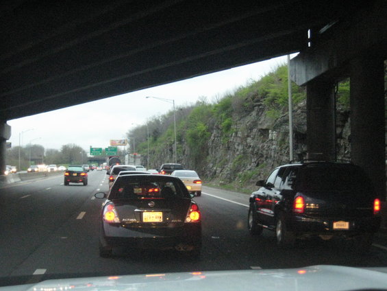 Traffic jam on a highway under an overpass with several cars visible