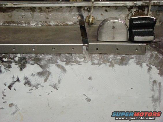 metal panel with grind marks and two metal blocks on top