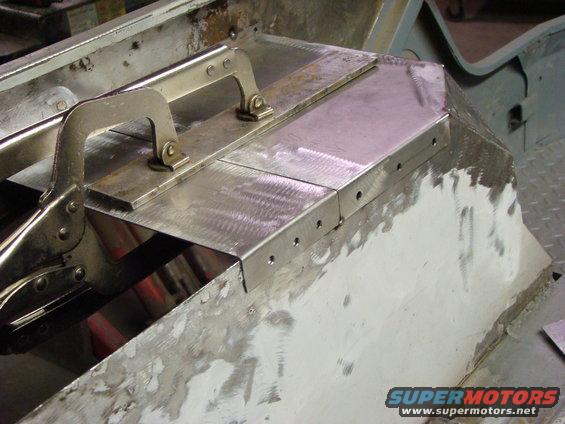 metal panels being clamped and prepped for welding on a vehicle body