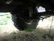 1987 Suzuki Samurai - Underside view of a 1987 Suzuki Samurai showing the rear leaf spring suspension and tire.