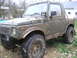 1987 Suzuki Samurai - This Suzuki Samurai is covered in mud, suggesting it has been off-roading.
