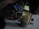 1995 Ford C-350 (Centurion Conversions) - Someone is using a phone to time draining fluid into a measuring jug.