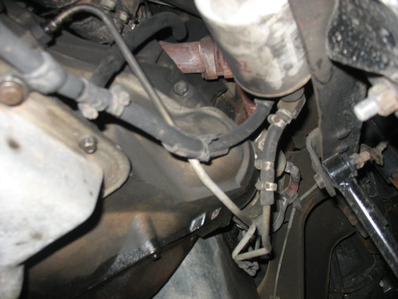 Engine and transmission components with hoses and filter