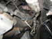 1995 Ford C-350 (Centurion Conversions) - Close-up view of engine and transmission components, including hoses and an oil filter.