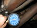 1995 Ford C-350 (Centurion Conversions) - Fuel pressure gauge connected to engine component for testing.