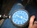1995 Ford C-350 (Centurion Conversions) - A blue compression gauge is held against a person's leg, showing pressure readings.