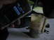 1995 Ford C-350 (Centurion Conversions) - A phone is held over a measuring jug during what appears to be an oil change.