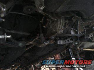 Underside of a vehicle with visible suspension components and exhaust system