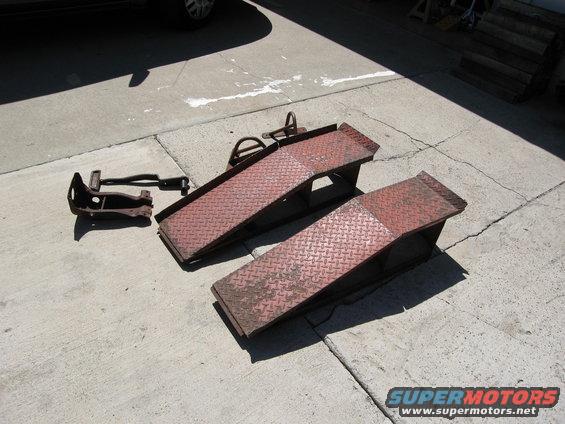 Car ramps and a suspension part on concrete