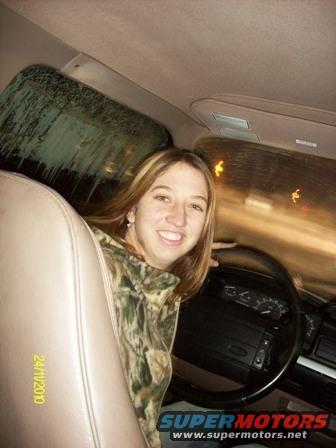Woman driving a 1995 Ford Bronco at night, view from passenger seat