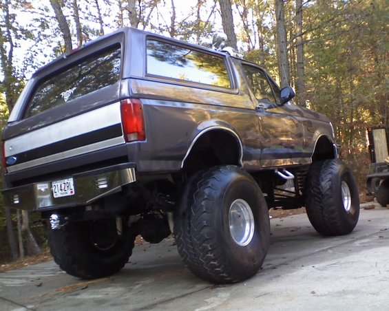 Lifted 1996 Ford Bronco, rear view, with large tires and chrome bumper