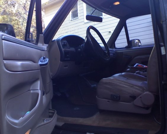 1996 Ford Bronco interior, showing driver's seat, dashboard, and door panel