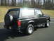 1996 Ford Bronco - This 1996 Ford Bronco is viewed from the rear three-quarter angle, showing its black exterior and spare tire.