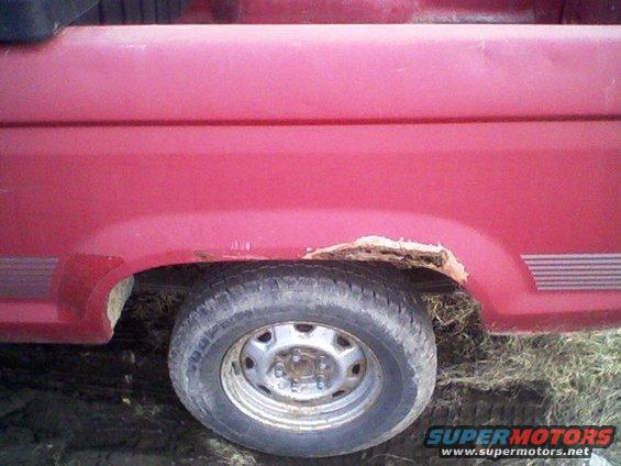 Red 1992 Ford Ranger side view showing rusted rear wheel well