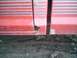 1992 Ford Ranger - Close-up of rust damage on a red truck's door seam, showing horizontal silver stripes.