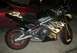 2008 Kawasaki Ninja R - A black motorcycle with prominent flame decals is parked next to a red car.
