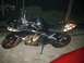 2008 Kawasaki Ninja R - This black motorcycle features flame decals on its side fairing and seat cowl, with red rims.