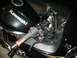 2008 Kawasaki Ninja R - A black Kawasaki motorcycle's handlebars and fuel tank are shown from a close-up perspective, revealing the brand name and controls.