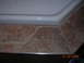 1984 Ford Bronco - Close-up of a white bathtub edge and tiled surround with water stains, dated 31.03.2009.