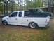 2000 Ford F-150 - White 2000 Ford F-150 pickup truck with custom wheels and lowered suspension.