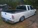 2000 Ford F-150 - This white 2000 Ford F-150 pickup truck features a lowered stance and custom chrome wheels.