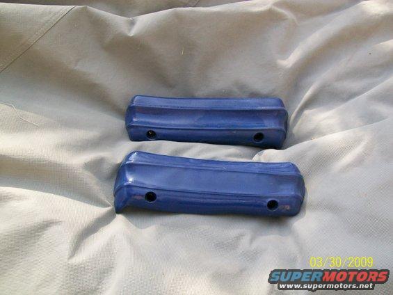 Two blue car door handles on a light-colored tarp
