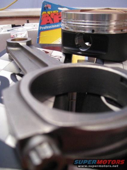 Connecting rod and piston with an AP Professional Gasket box in the background