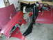 1994 Ford F-250 - Various red body parts, including a fender and door, are laid out in a garage, possibly for a 1994 Ford F-250.