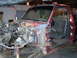 1994 Ford F-250 - This red pickup truck is in a state of disassembly, with its front end and engine compartment open.
