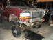 1994 Ford F-250 - This red Ford F-series truck is undergoing front-end repairs, with its grille and bumper removed.