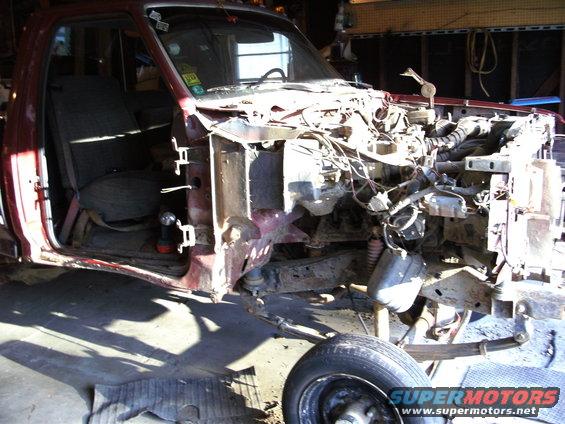 1994 Ford F-250 disassembled in garage, showing chassis and interior