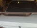 1995 Ford Bronco - The rear of a car is shown with a spoiler and a website address at the bottom.