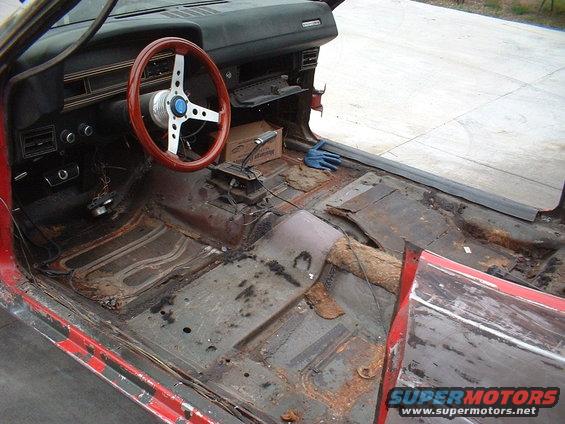 1970 Ford Torino interior, red exterior, rusty floor pans, aftermarket steering wheel, manual transmission