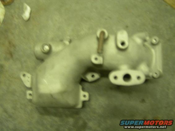 Aluminum intake manifold with two bolt holes and a central opening