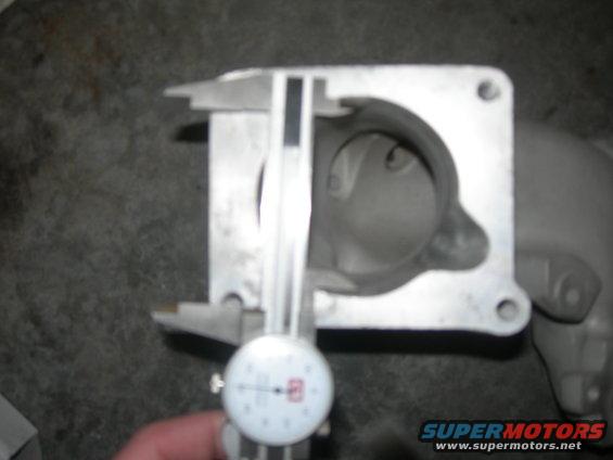 Throttle body being measured with a caliper