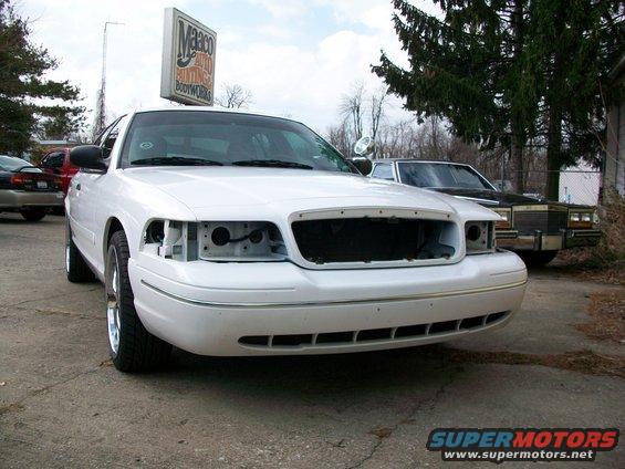 White 2003 Ford Crown Victoria front view, missing grille and headlights